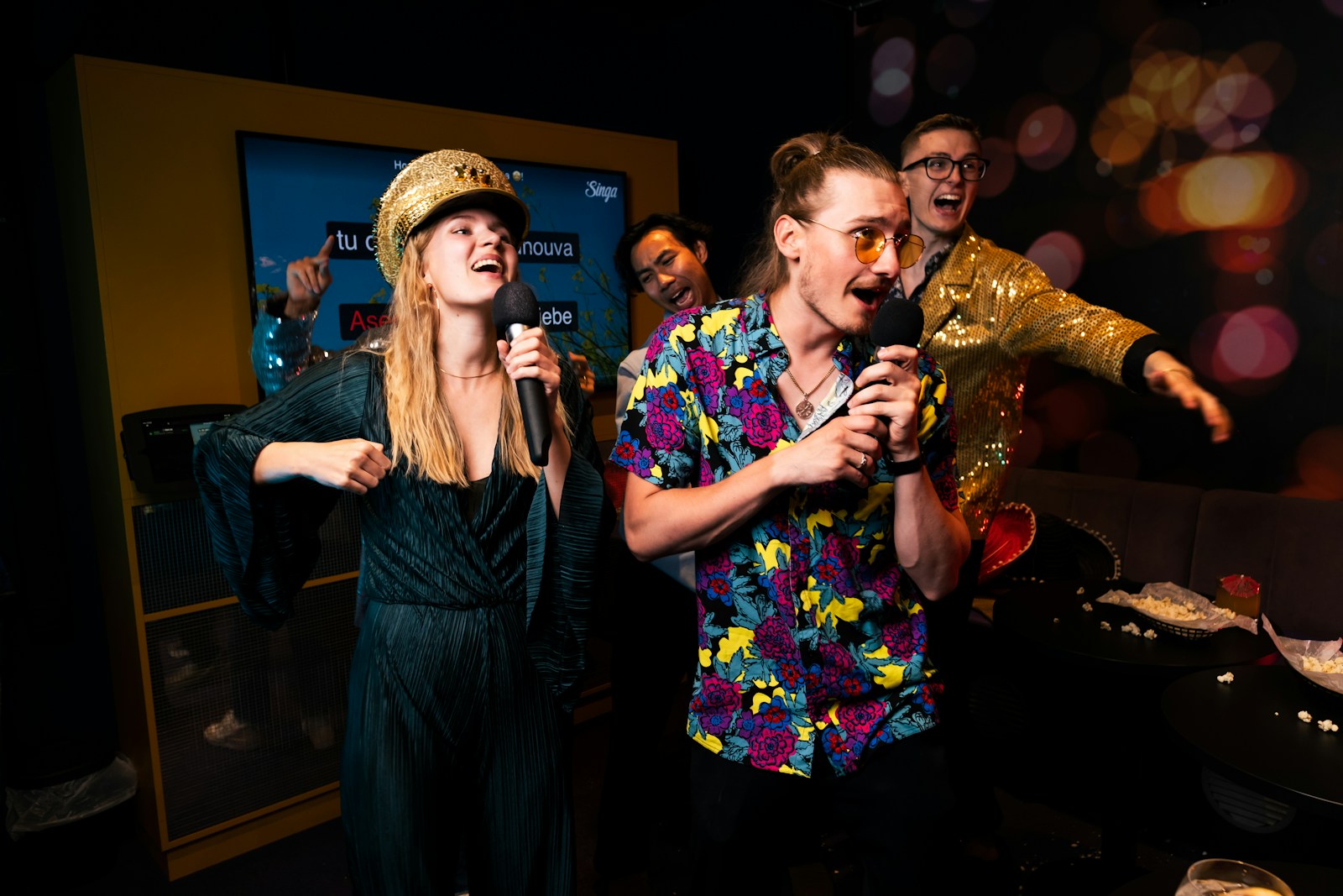 A group of people standing around each other in a room